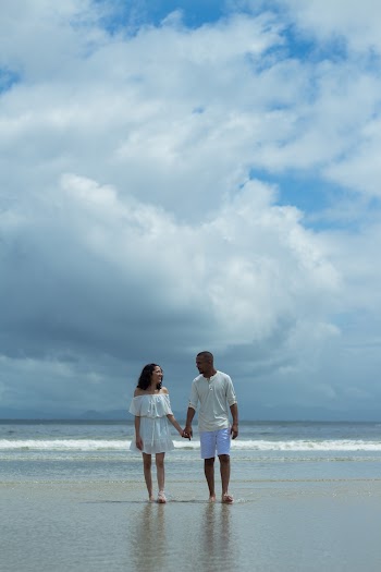 A Man and a Woman Walking on a Beach Holding Hands