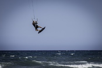 A Man Kite Surfing At Sea