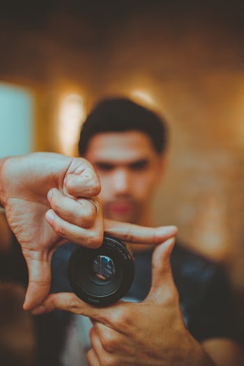 A Man Showing A Camera Lens