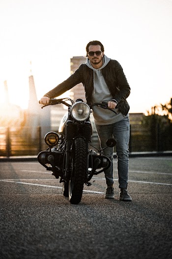 A Man Showing His Bike In A Parking Area