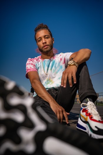 A Man Sitting On The Pavement