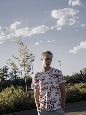 A Man Wearing A Company Branded Shirt