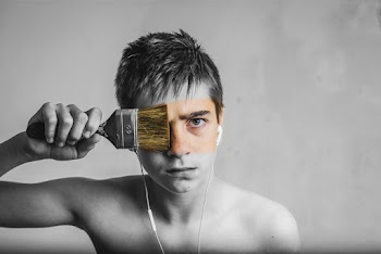 A Man With A Paint Brush Across His Face
