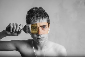 A Man With A Paint Brush Across His Face