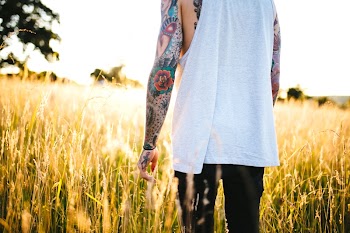 A man with tattoos in the field. | Free Photo - rawpixel