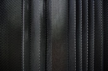 A metal criss-cross grid in undulating layers