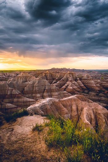 A morning storm in the Badlands being chased away by the rising sun.  One of those moments that leave you standing there speechless in awe of the beauty. 