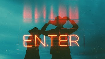 A Neon Signage With Two  Person Behind