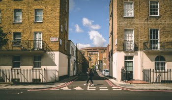 A pedestrian crossed a side-street along Gloucester Place in West London. 
