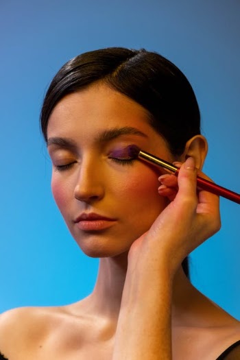 A Person Applying Eyeshadow Makeup to a Woman · Free Stock Photo