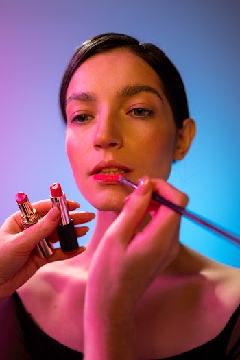 A Person Applying Lipstick to a Beautiful Woman · Free Stock Photo