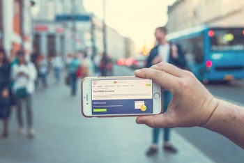 A Person Holding a White and Gray Smartphone