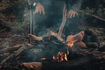 A Person Sitting Beside the Bonfire