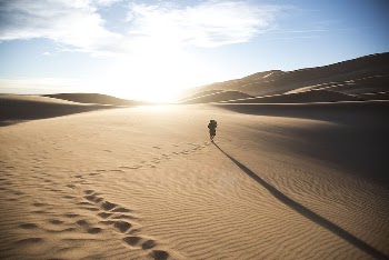 A person walking through the sand, | Free Photo - rawpixel