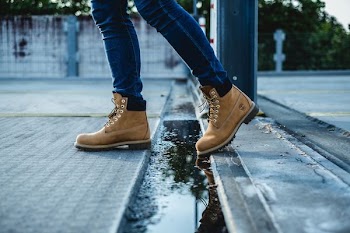 A person walks in the street wearing Timberland boots