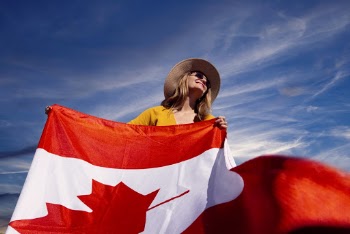 A Photograph of a Woman Holding a Canadian Flag