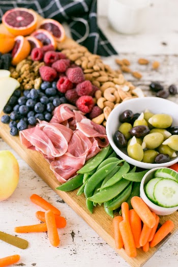 A platter of veggies, fruits, nuts and seeds. Whole30 approved. 