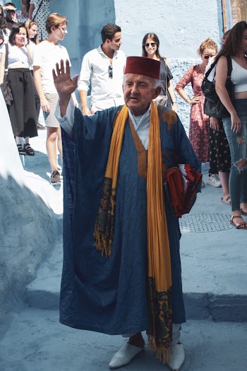 A Priest Waving His Hand To People