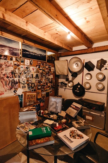 A Room Full Of Pictures On The Wall  And  Assorted Books on Table
