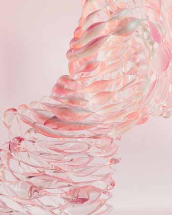 a sculpture made of pink and white glass