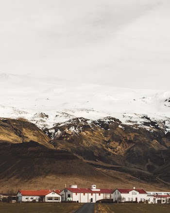 A Small Town On The Foot Of Snow Capped Mountains