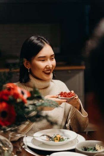 A Smiling Woman Holding a Food · Free Stock Photo
