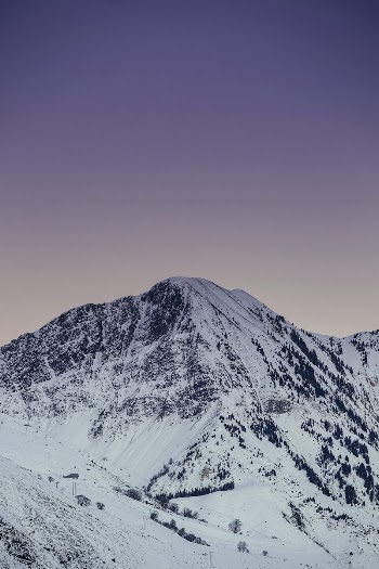 A snow-covered mountain against a light | Free Photo - rawpixel