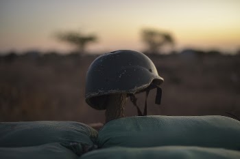 A soldier's helmet rests on a post | Free Photo - rawpixel