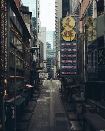 A sole person standing right in the middle of otherwise empty Hong Kong’s street. I took this picture during the morning rush hour. After few seconds the street was full of people and cars again. 