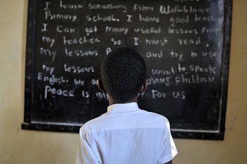 A Somali boy reads from the board | Free Photo - rawpixel