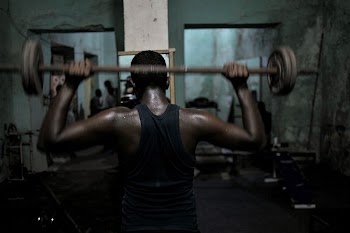 A Somali man lifts weights | Free Photo - rawpixel