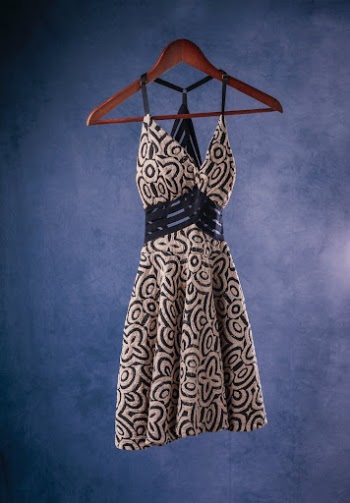 A Spaghetti Black and White Dress Hanging on a Wooden Hanger