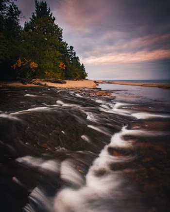 A stream flows into Lake Superior at Pictured Rocks National Lakeshore, Michigan, USA. 