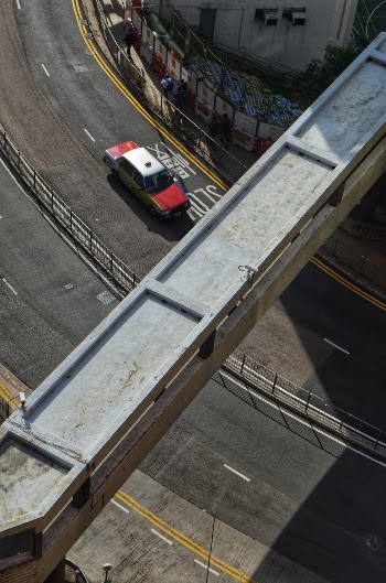 A taxi on a road in Mid-Levels, as seen from the University of Hong Kong