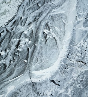 A top down aerial perspective of the icy path leading to the base of the Sólheimajökull glacier.