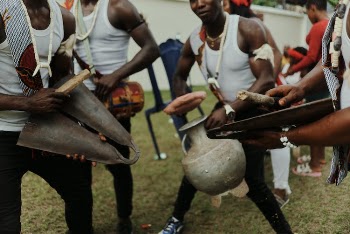 A Tribe of Men Playing Indigenous Musical Instrument