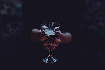 A witch holding a glass of wine 2
