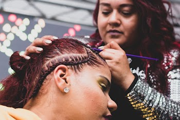 A woman braiding another woman
