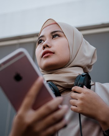 A Woman Holding His Cellular Phone