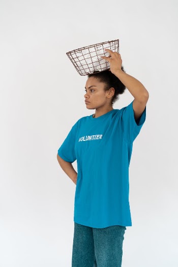 A Woman in Blue Shirt Holding a Metal Basket