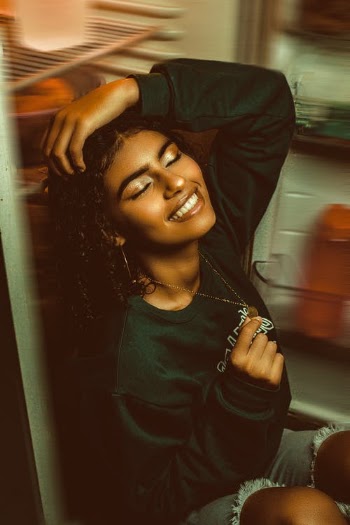 A Woman Leaning on an Open Refrigerator · Free Stock Photo