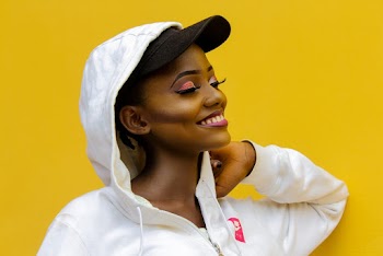 a woman posing with her eyes closed
