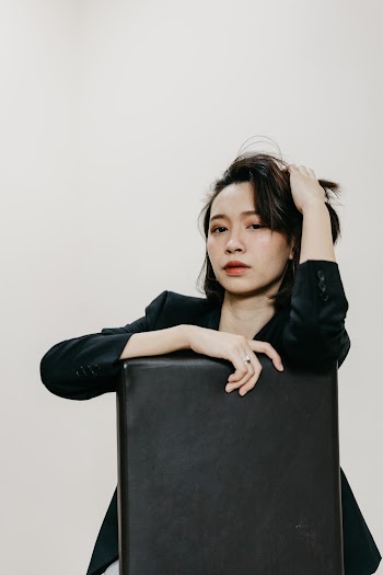 A Woman Seated  On A Chair 