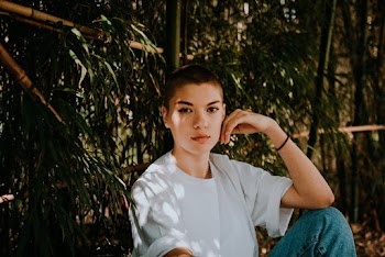a woman Sitting Beside Bamboos