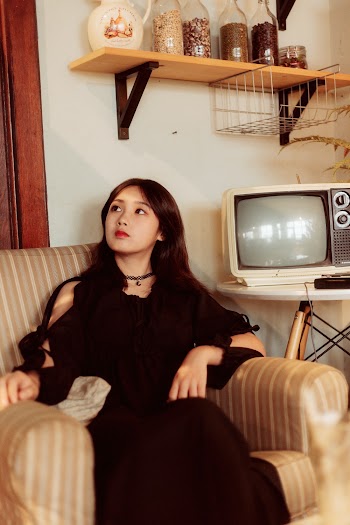 A Woman Sitting on a Sofa Chair