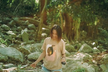 A Woman Standing Beside Rocks