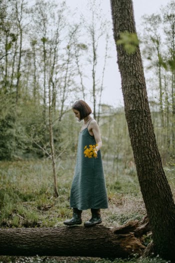 A Woman Stepping on a Fallen Tree · Free Stock Photo