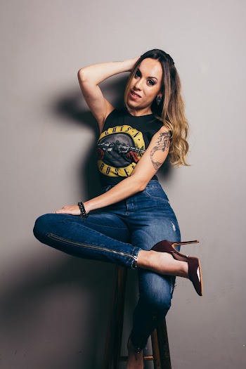 A Woman Wearing Black Sleeve-less and Blue Denim Jeans