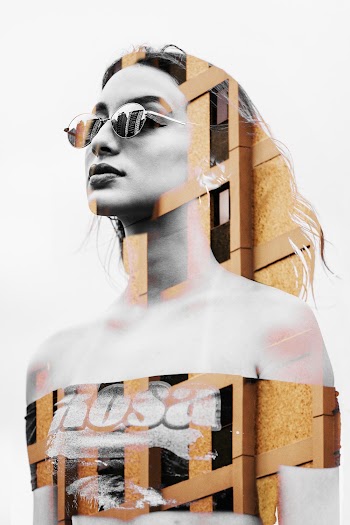 A Woman Wearing Sunglasses Pasted On A Building Wall