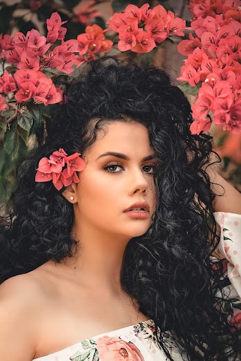 A Woman With A Curly Black Long Hair
